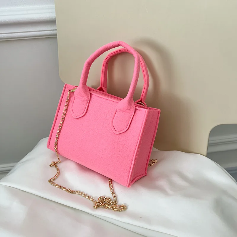 

Design small candy-colored hand-held bag for female in summer, 2022, a new fashion cute handbag with one shoulder slung over.