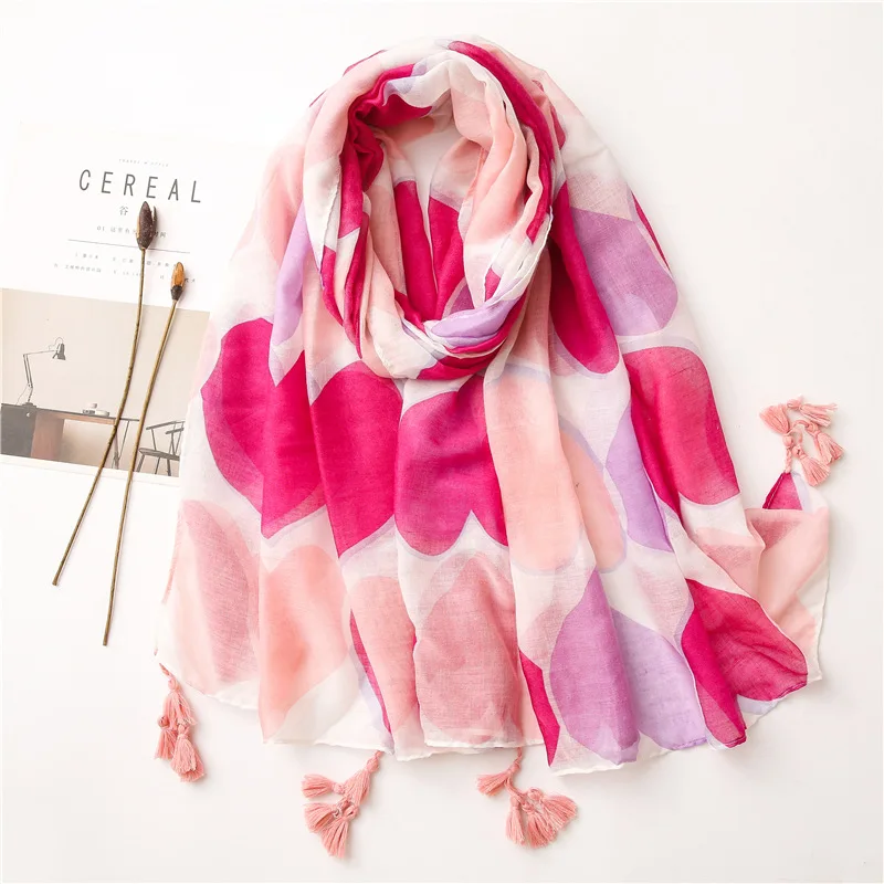 

A thin pink peach heart scarf and a long beach towel in summer