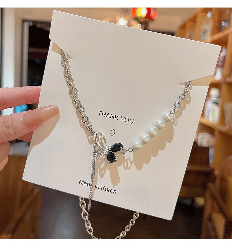 

Light luxury niche black zircon butterfly titanium steel necklace women's senior design sense temperament splicing pearl clavicl