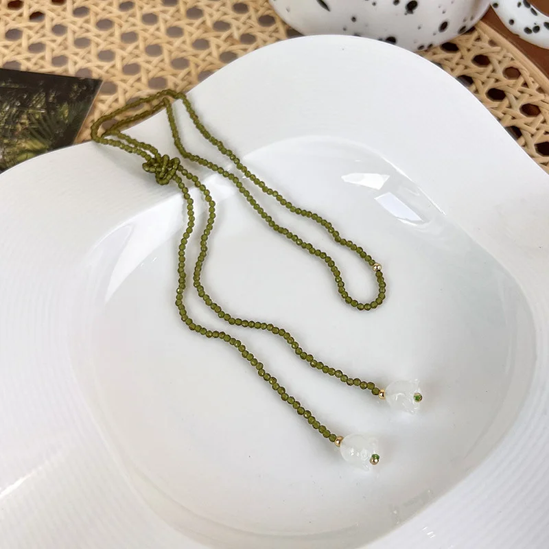 

Minar Stylish Green Color Beads Strand Long Tassel Necklace for Women White Color Stone Simulation Bell Orchid Pendant Necklaces