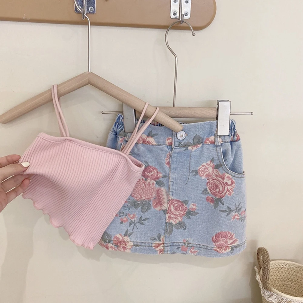 

Новинка, корейский стиль, костюм для девочек, модный однотонный жилет на бретелях + джинсовая юбка с цветочным принтом для девочек, 2 предмета одежды