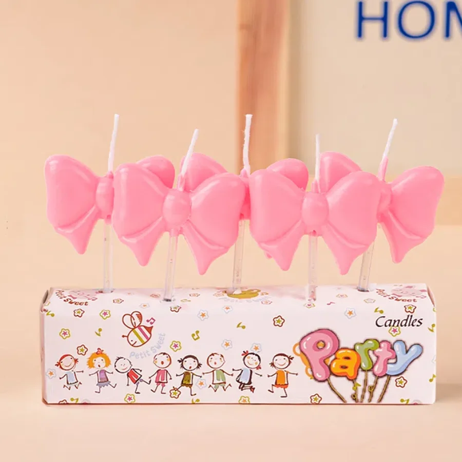 

Розовая свеча-бант для торта