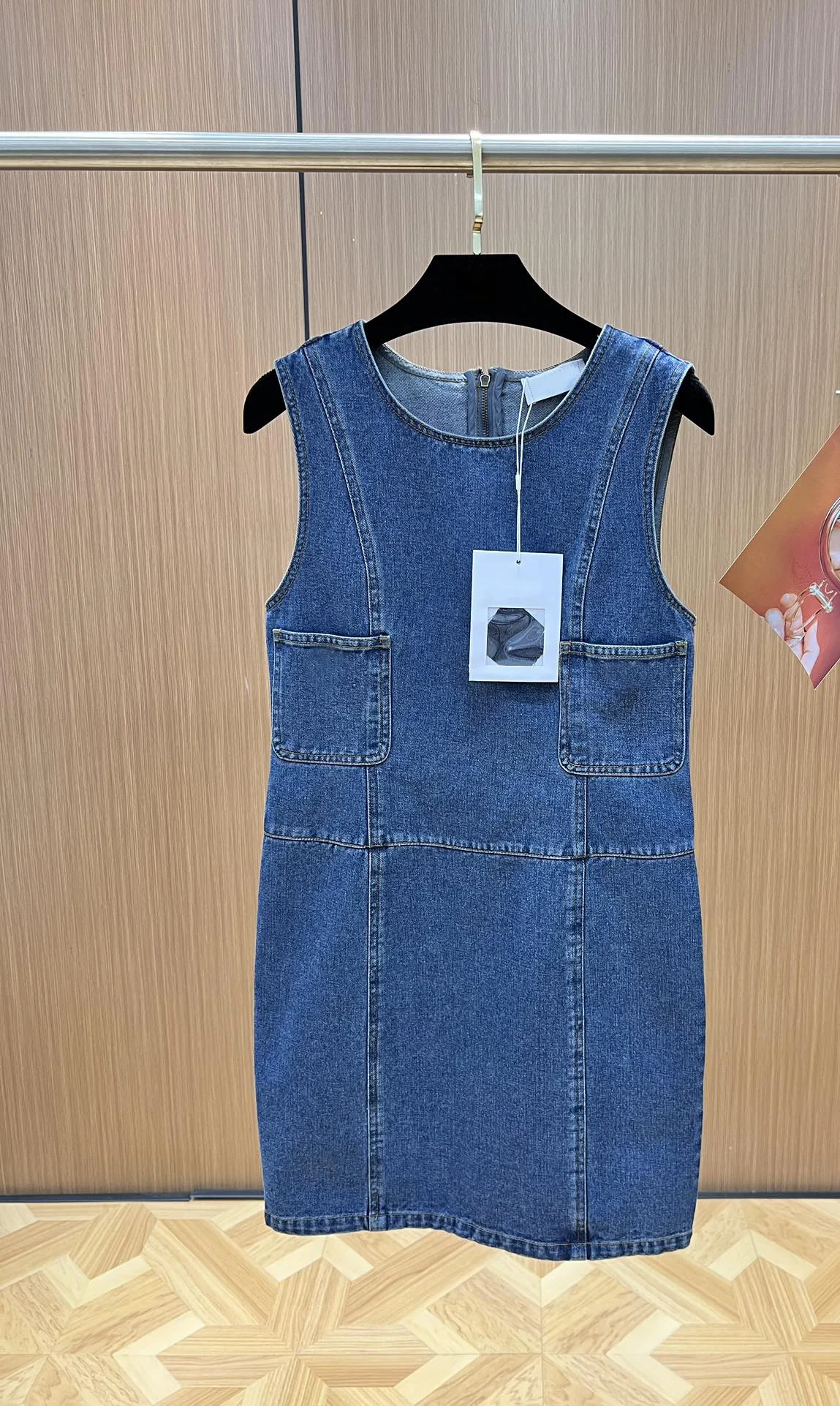 The Summer 2023 classic blue denim sleeveless dress features a simple design paired with colorful floral buttons6.27