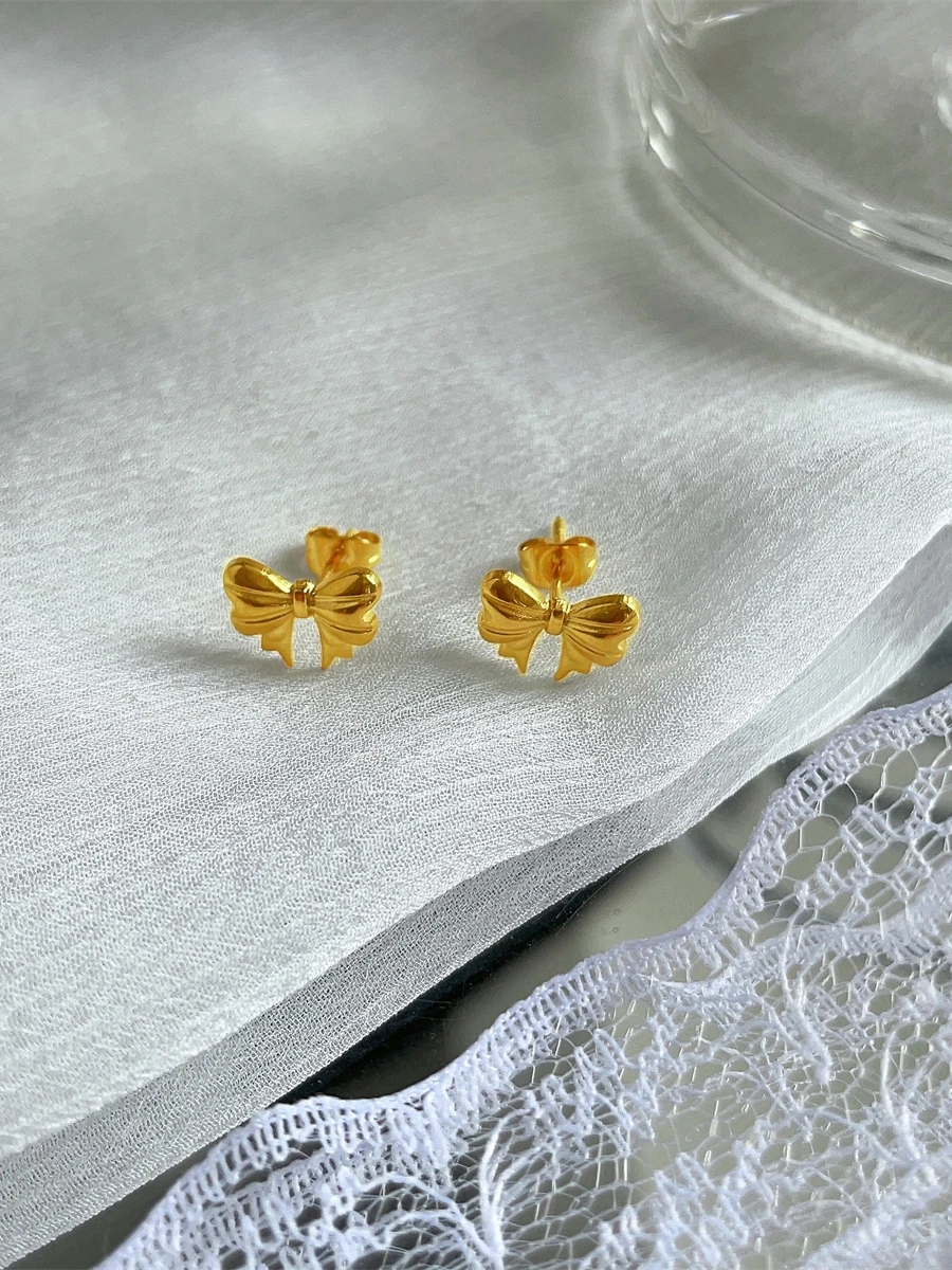 Серьги-гвоздики принцессы с бантом завернутые из 8-каратного золота не