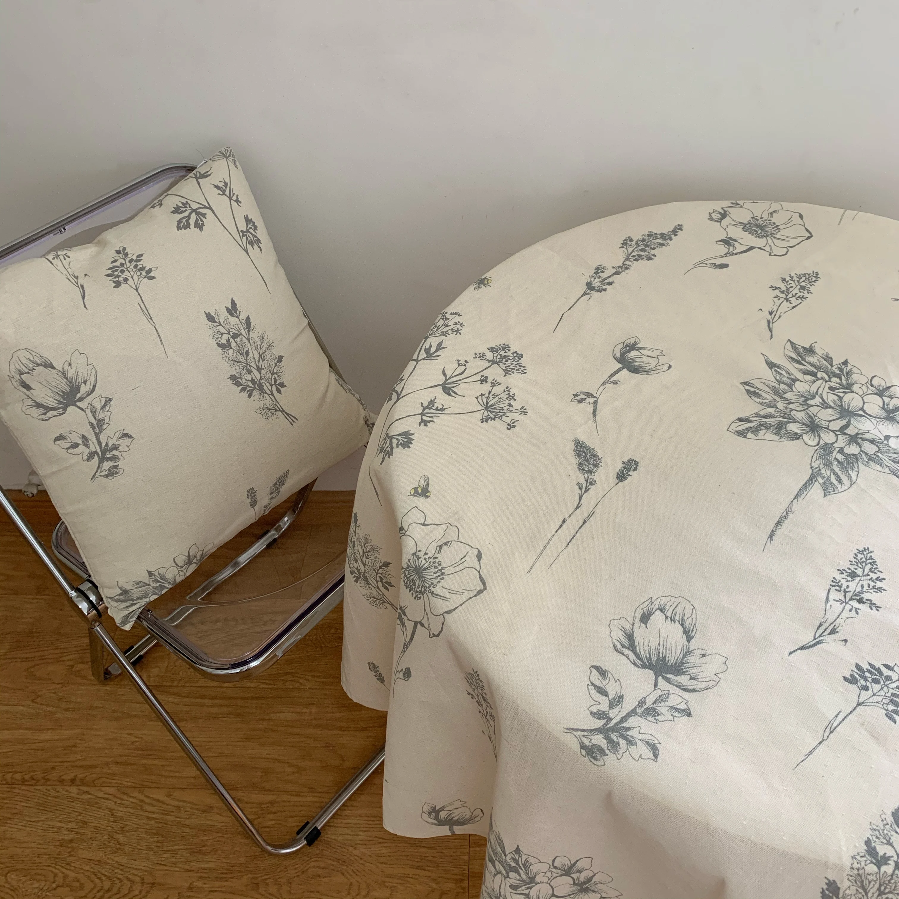 

Black and white sketched flowers, little bees, and plant printed tablecloth