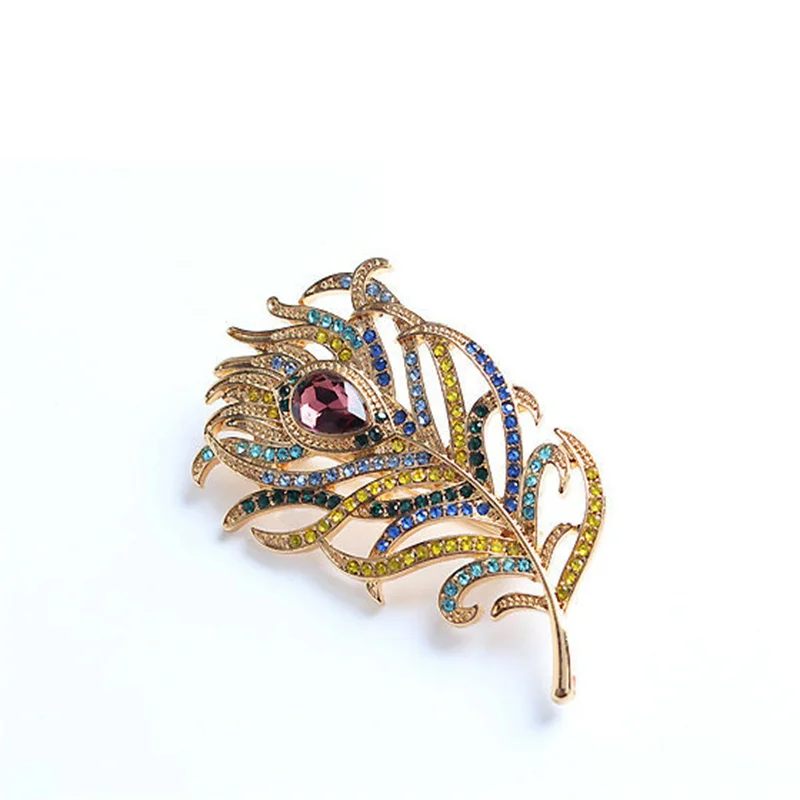 

Винтажная золотистая брошь в виде пера павлина