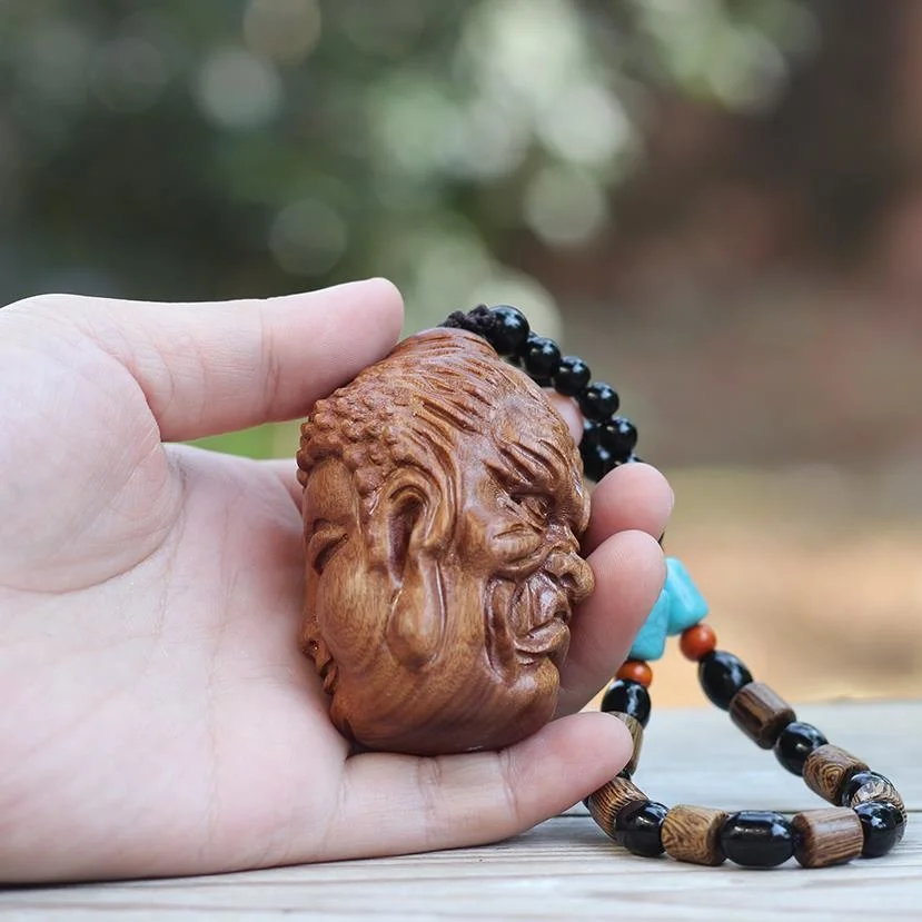 

Natural Lao Huang pear wood carving between the idea of good and evil hand pieces of rosewood hand carried play pieces