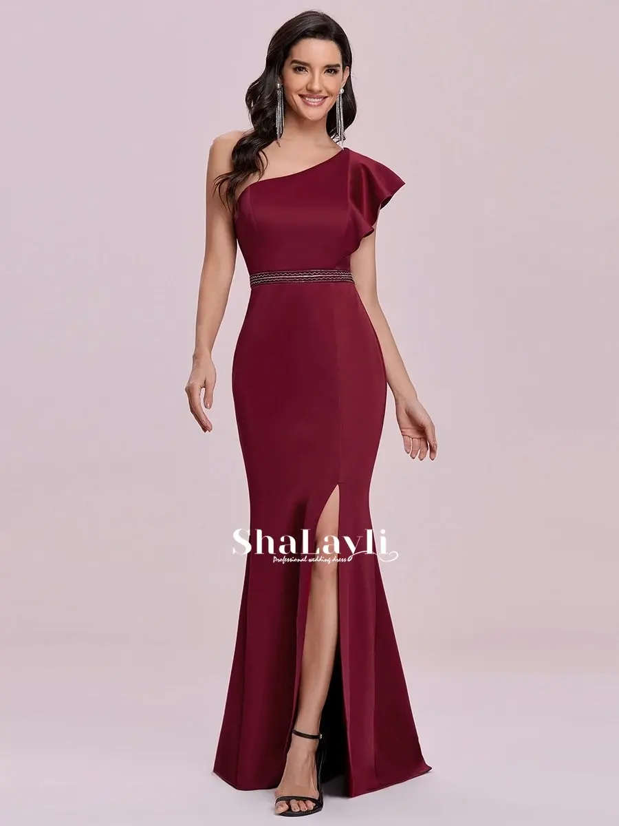 

Бордовое красное элегантное вечернее платье макси на одно плечо оптом с разрезом сбоку свадебное платье русалки с поясом без рукавов с рюша...