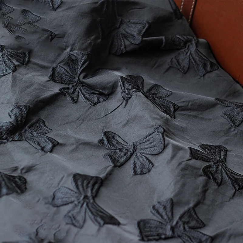 

Yarn Dyed Embossed Black Bow Jacquard Fabric Stiff Polyester Autumn and Winter Jacquard Dress Fabric 50cmx140cm