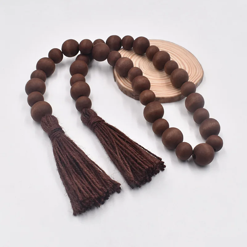 

Деревянная гирлянда из бусин с кисточкой