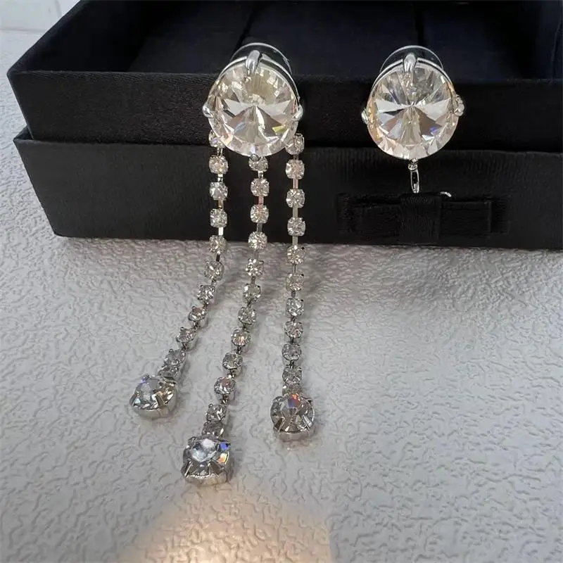 

New bow earrings are light, luxurious, and sweet, with an asymmetrical diamond embellishment. Long tassel women's earrings