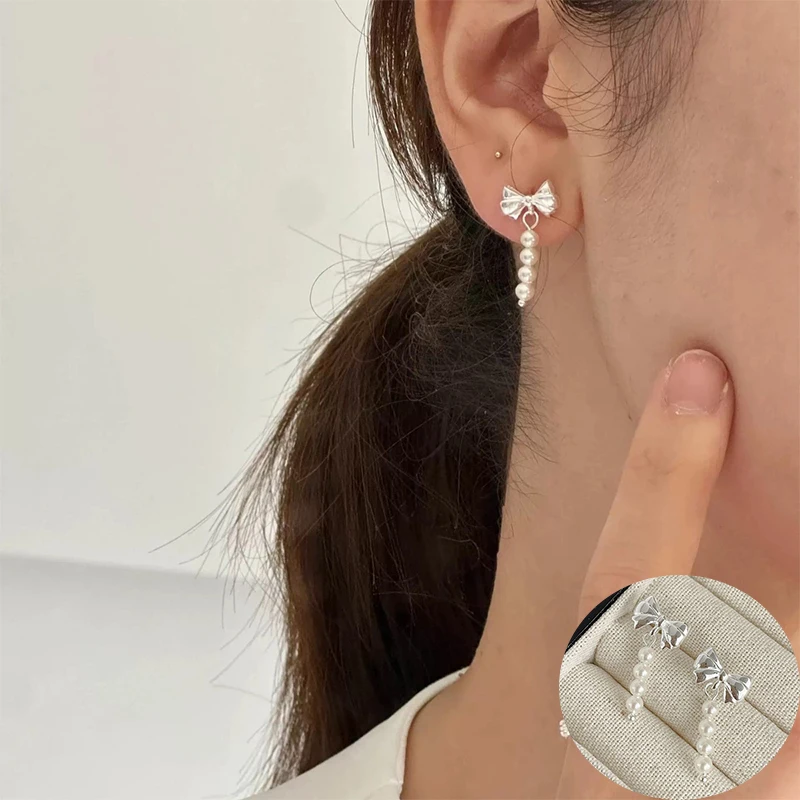 Женские серьги-подвески из серебра 100% пробы с жемчугом и бантом