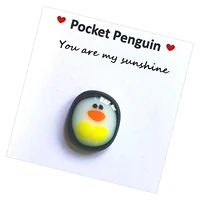 a little pocket penguin hug miniature penguin figurine miniature penguin shows a huge amount of care for her keepsake ornament