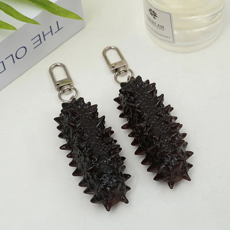 

Simulation Small Sea Cucumber Food Key Chain Creative Fake Sea Cucumber Ornaments Seafood Photography Props Schoolbag Pendant