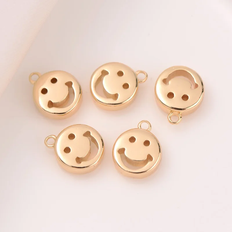 

Gold covered light gold three-dimensional hollow round smiley face pendant handmade diy bracelet pendant necklace pendant
