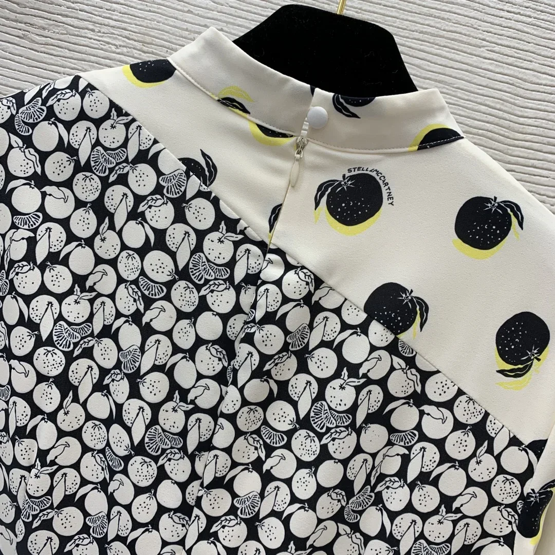 

Ladylike contrasting panels, fruit print, split front design, nipped-in waist to show slim stand up collar, long-sleeved dress