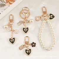 new pearl love car alloy key chain pendant small fragrance creative bow tie love brand bag pendant