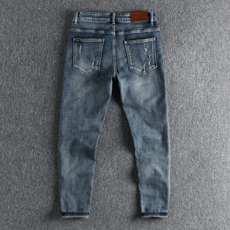 Simple retro jeans with old holes, men's personalized trousers with rotten edges, slim feet, nine-minute pants and boots.
