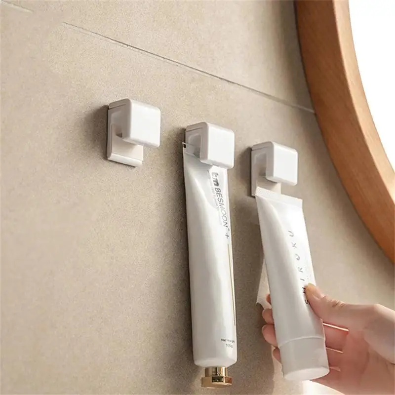 

Wall-mounted Toothpaste Holder Facial Cleanser Clip Self Adhesive Organizer Bathroom Accessories Toothpaste Hanging Holder Clip