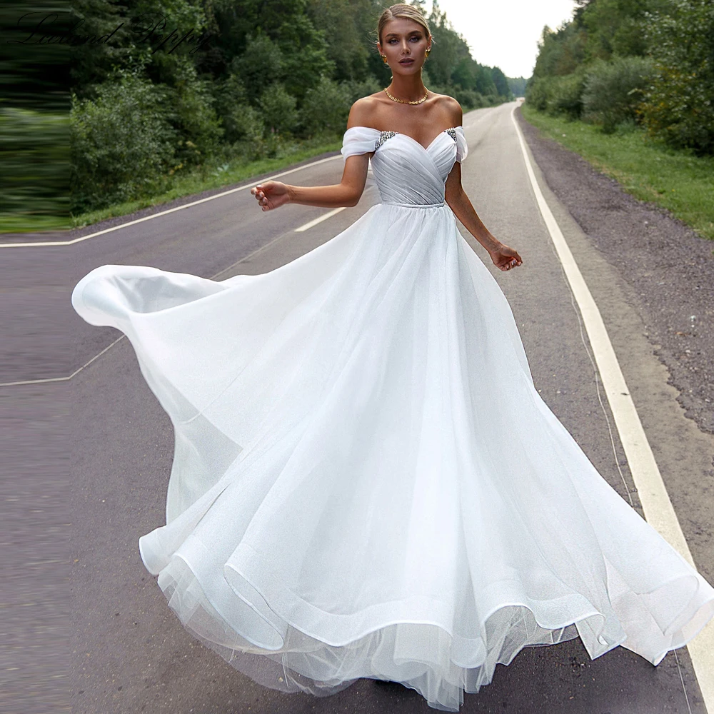 

Lceland Poppy Women's A Line Boat Neck Tulle Wedding Dresses Short Sleeves Floor Length Beaded Bridal Gowns with Pleats