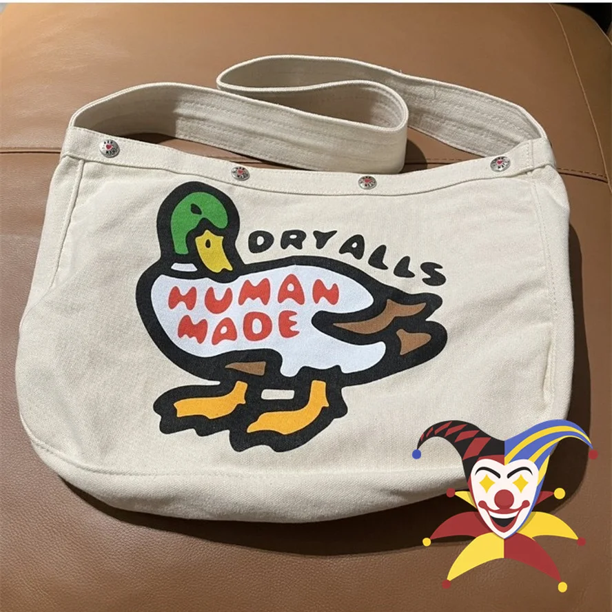 

Khaki Canvas Human Made Duck Backpacks Men Women Cartoon Graphic Snap Button Human Made Bag Heart Logo Bag