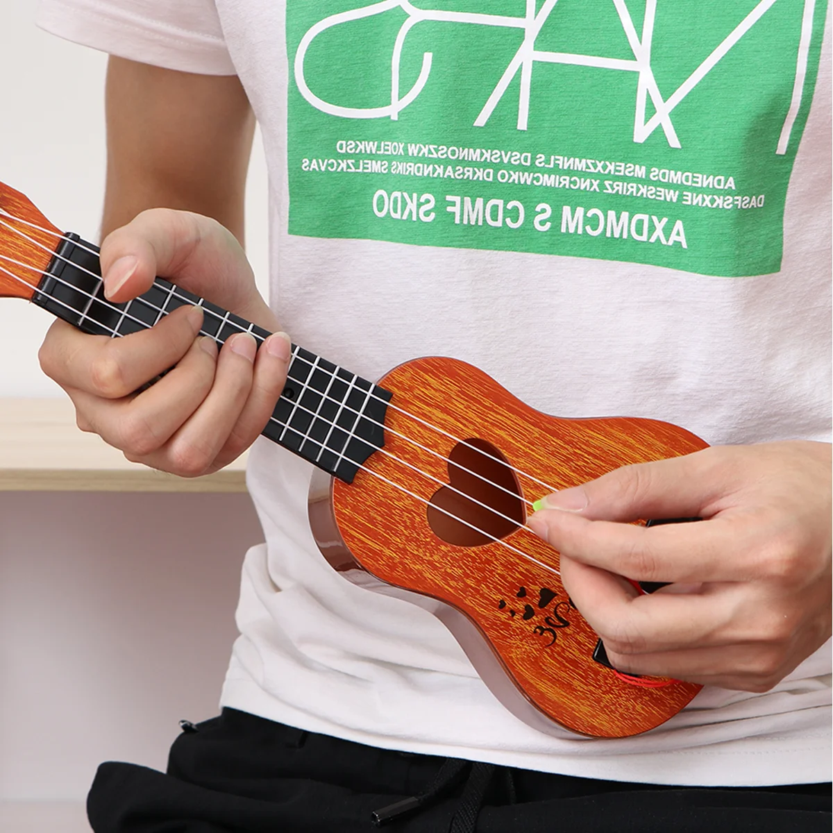 

Children Small Size Musical Instruments Imitated Ukulele Mini Guitar Playing Toy with Four Strings