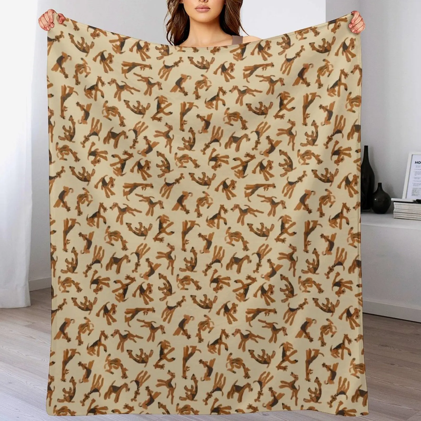 Роман из Airedales на брошенном одеяле