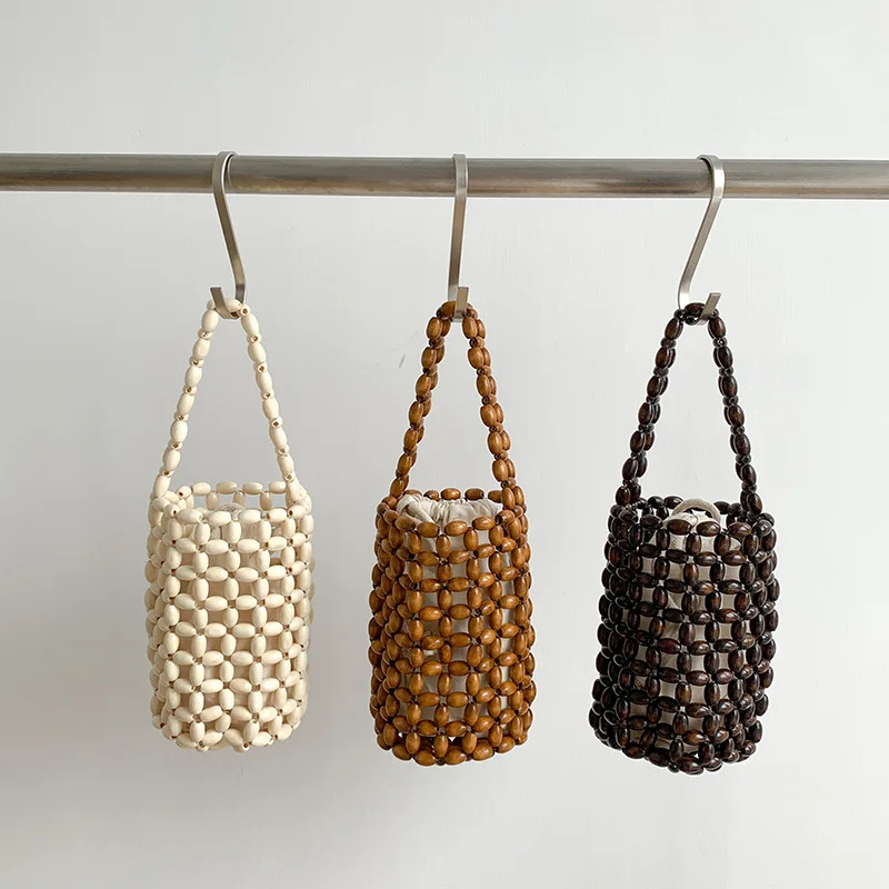 

2022Summer New Ladies Bucket Bag Hand-woven Women Bag Fashion Pearl Wooden Beads Beach Little Hollow Transparent Inner Bag Tote