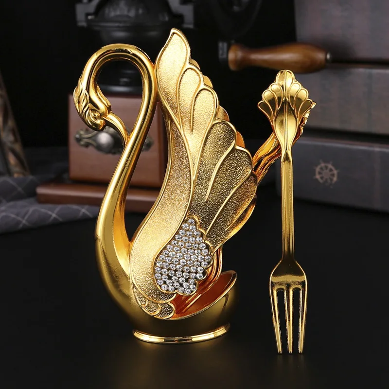 

Набор ложек и вилок из металла с держателем в виде лебедя