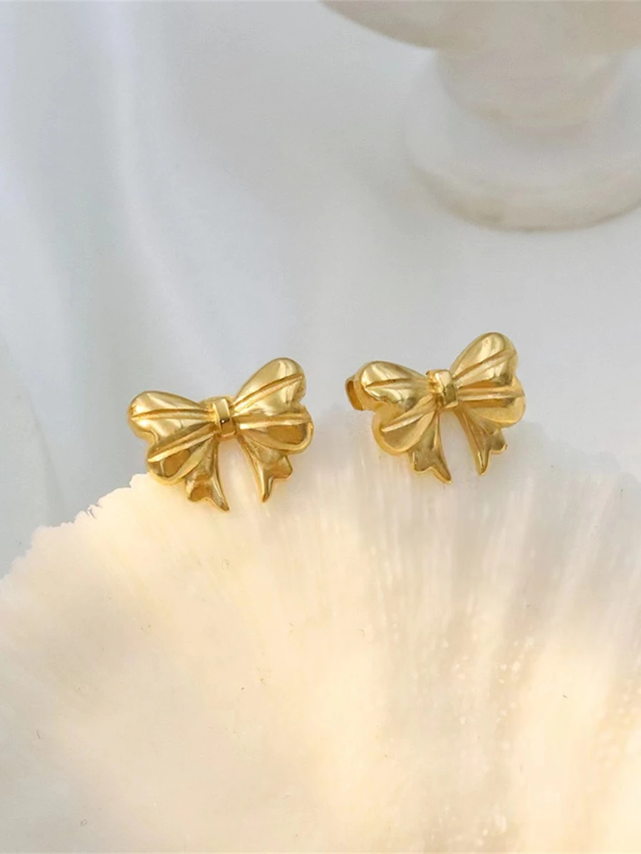 Серьги-гвоздики принцессы с бантом завернутые из 8-каратного золота не