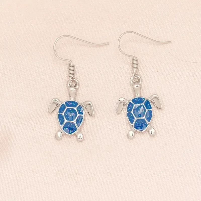 Серьги-гвоздики из белого белка королевского синего черепахи с подвеской в виде