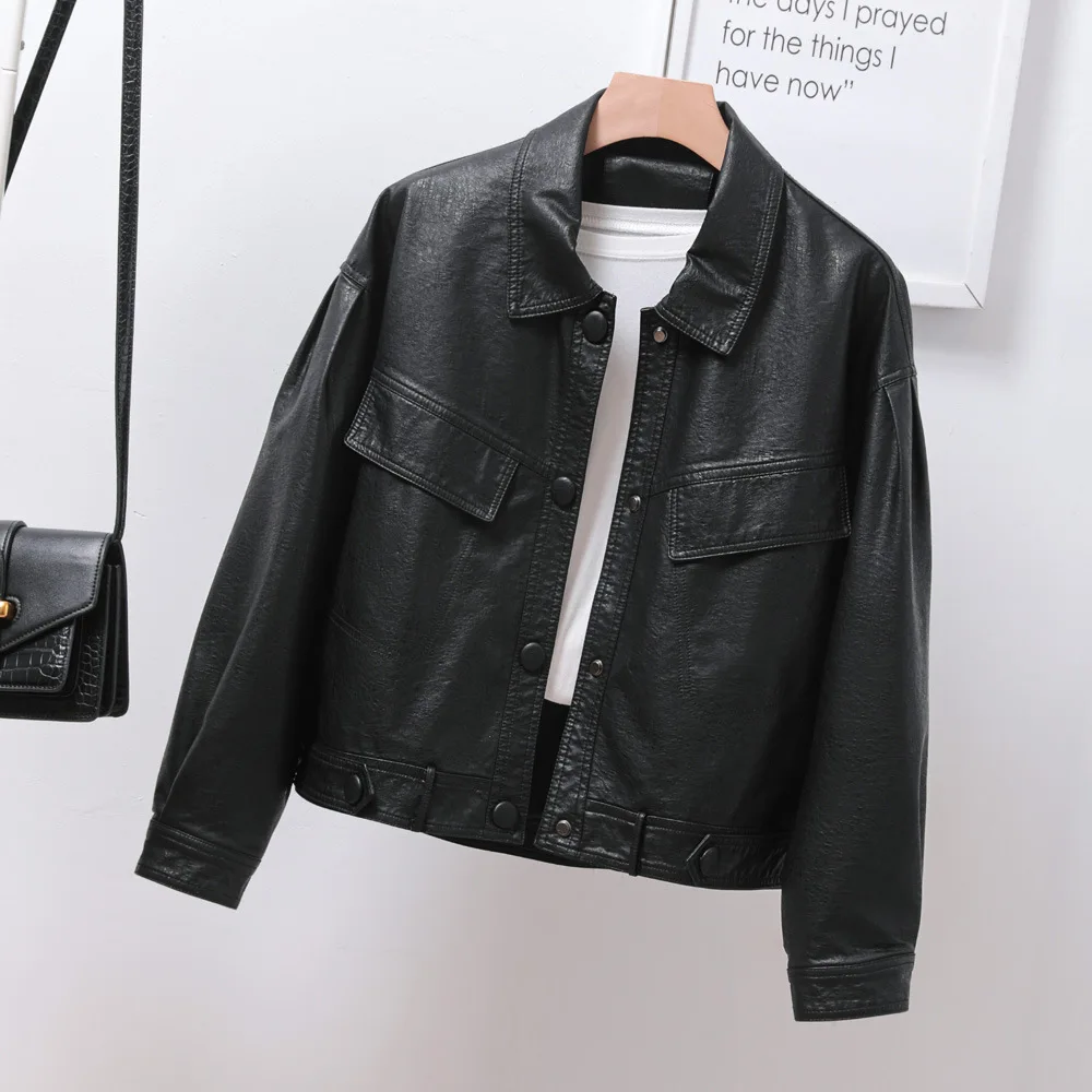 Single breasted loose version of women's short black lapel leather coat