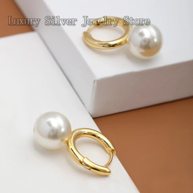 

The Triumphal Arch collection of fashionable and luxurious gold pearl earrings with boxed jewelry as a gift for your girlfriend