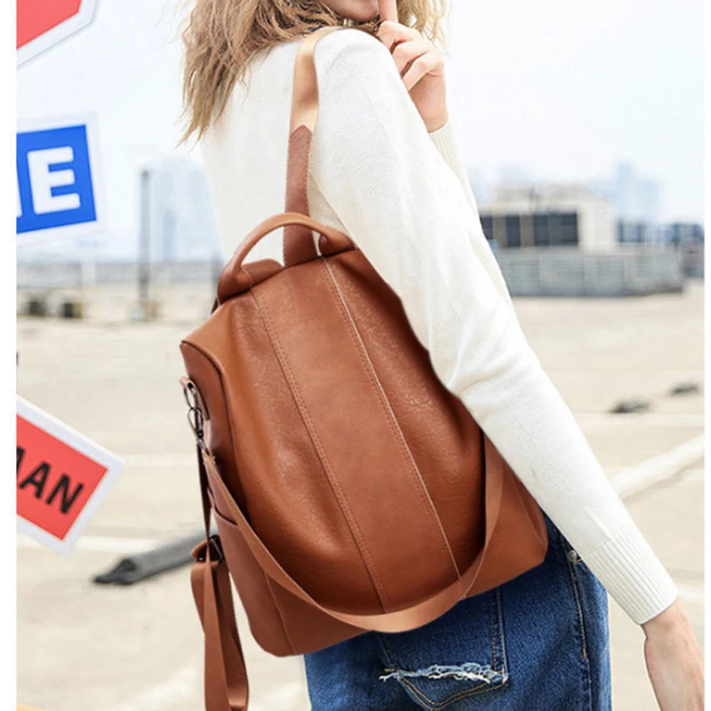

Качественный кожаный женский рюкзак с защитой от кражи, вместительная школьная сумка с помпоном для девочек-подростков, мужские дорожные с...