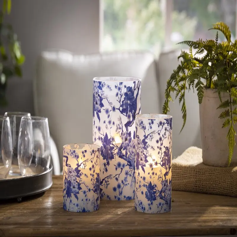 

Free Shipping 5-in D x 8-in H Hand poured Wax Candle in blue floral patterned frosted glass with exclusive ™ glow