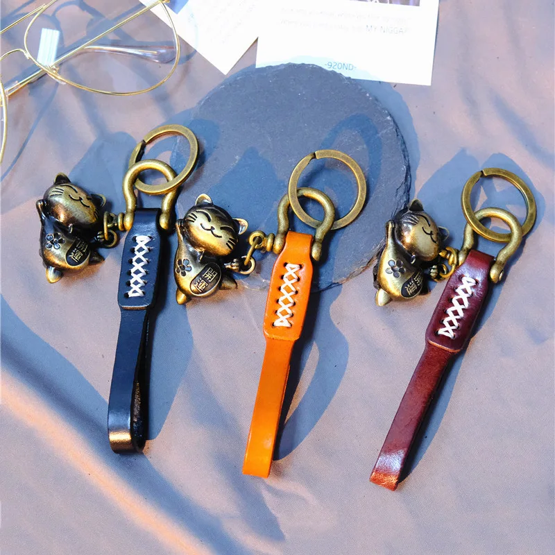 Ключница для автомобиля 2023 роскошного милого оберега-кота из натуральной кожаной веревки для мужчин и женщин, лучший подарок для мужчин, высокое качество.