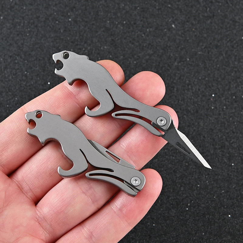 

Titanium alloy folding knife EDC camping equipment unboxing mini knife keychain hanging folding knife leopard bottle opener