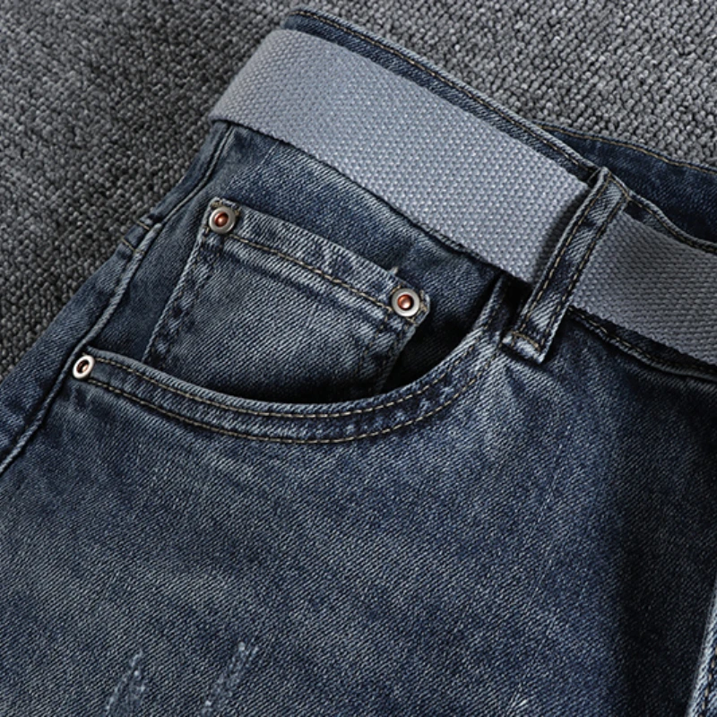 With a belt, vintage blue jeans, slim fit, snug little bullet hole, teeny feet