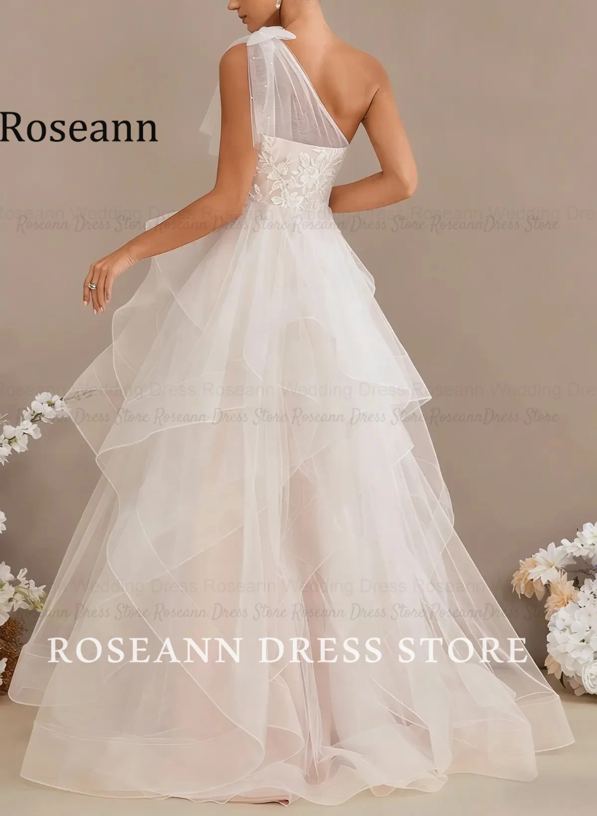 Фото Свадебное платье Roseann с бантом, на одно плечо, кружевное, с эффектом иллюзии, многоярусное, с рюшами из тюля, А-силуэт, с шлейфом, свадебное платье на заказ. №4