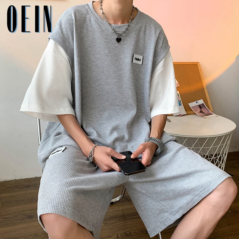 

Летний мужской спортивный костюм большого размера, воздухопроницаемые повседневные комплекты одежды, Повседневная футболка с имитацией двух предметов и шорты в стиле High Street, спортивный костюм