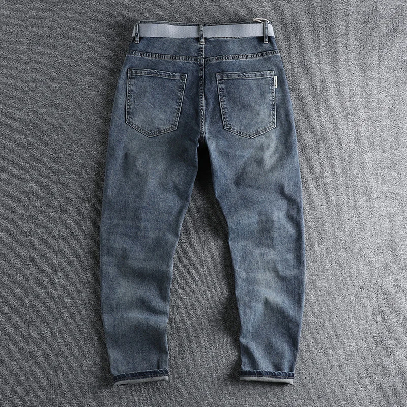 With a belt, vintage blue jeans, slim fit, snug little bullet hole, teeny feet