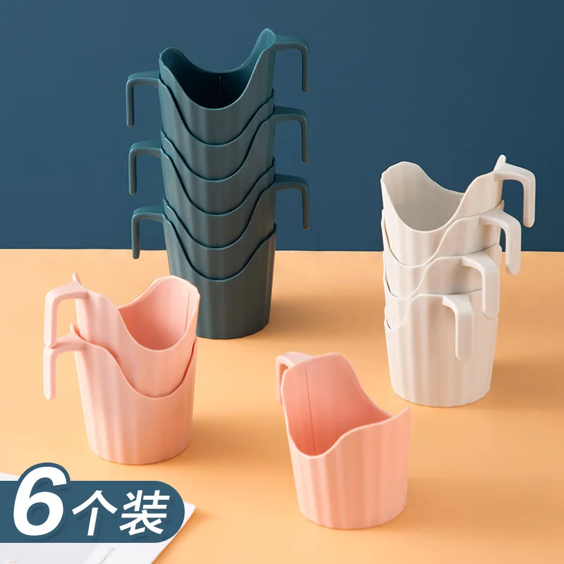 

Disposable paper cup with thick plastic corrugated beverage holder base insulation against the hot cup of tea ceremony