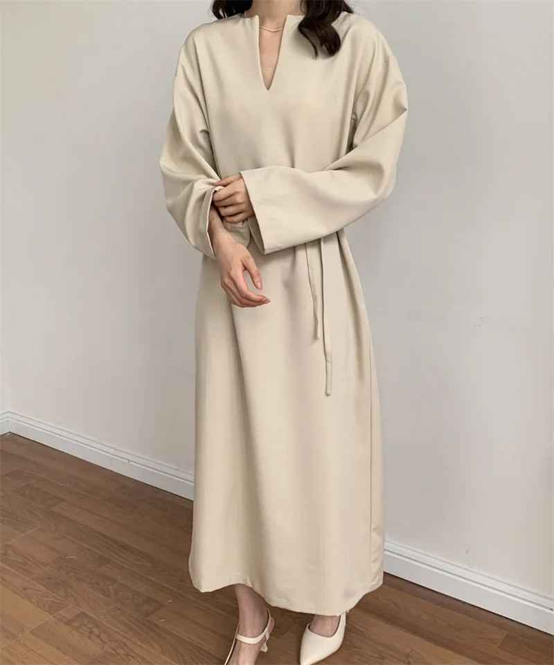 

A minimalist lazy autumn/winter loose fitting solid color long sleeved V-neck over knee length dress with a niche temperament.