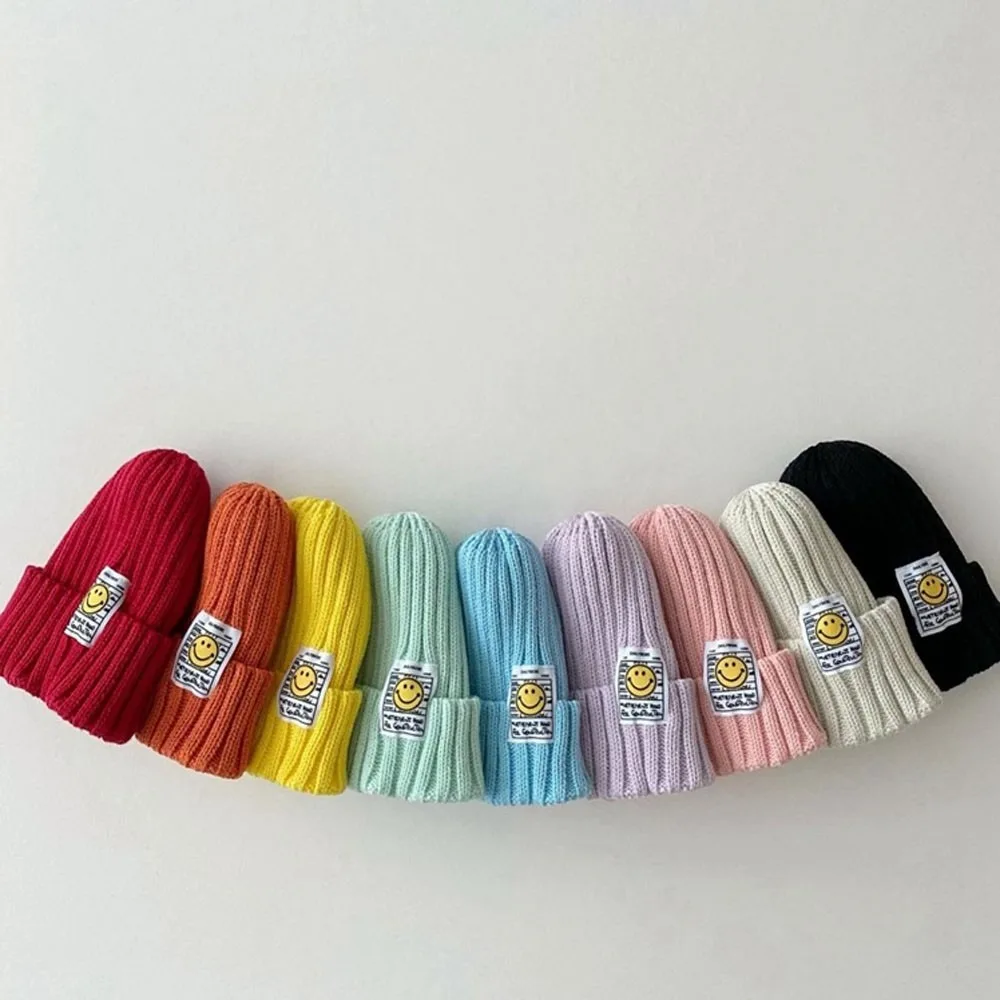 

2023 Autumn Winter New Candy Color Knitted Hats Girls Smiling Face Patch Stretch Woolen Hat Cotton Boys Baby Boutique Cute Hats