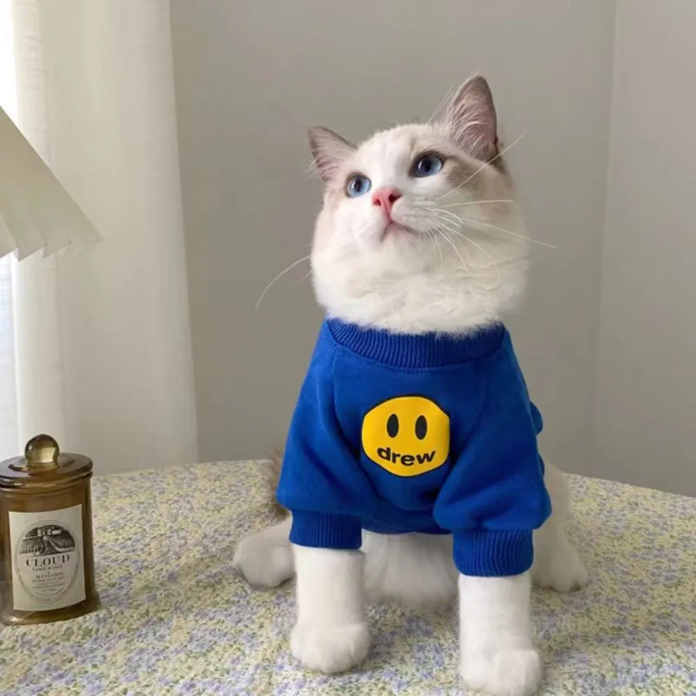 

New Winter Pet Cat Clothes Fashion Brand Autumn and Winter Little Milk Cat Anti shedding Smiling Face Sweater Cat Autumn Clothes