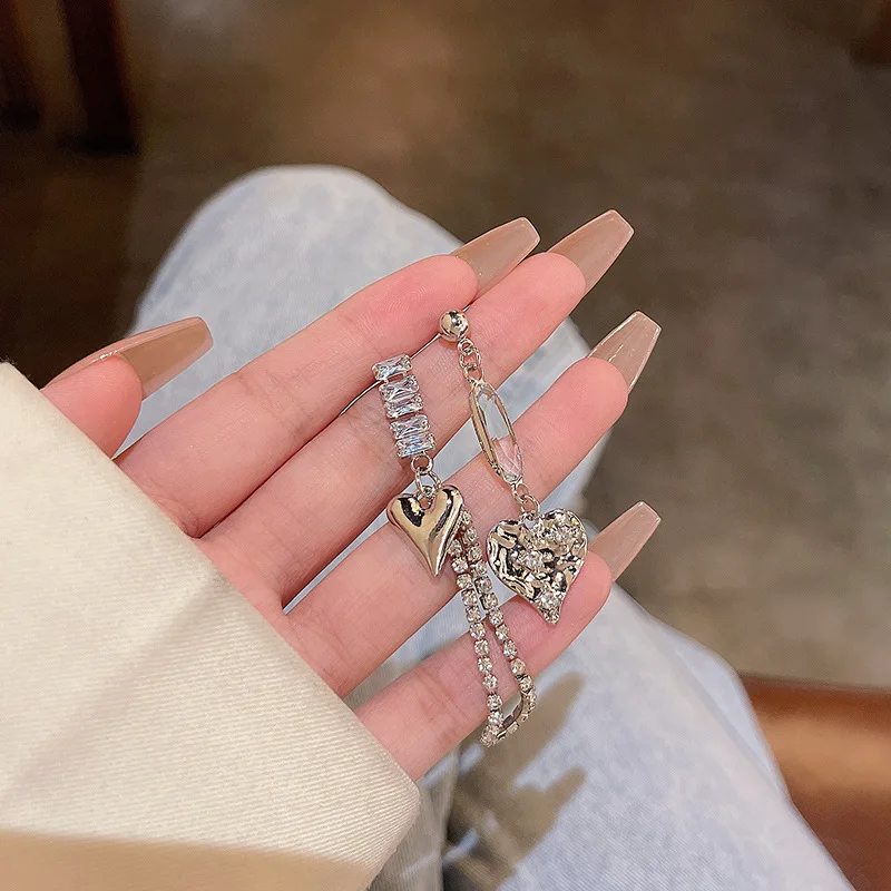 

The same super fairy temperament asymmetric love earrings women's S925 silver needle light luxury niche micro-set zircon stud