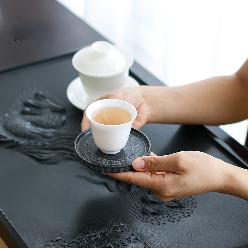 

Natural black gold stone cup pad Tea cup holder Household simple stone tea holder Handmade heat insulation pot pad Tea set