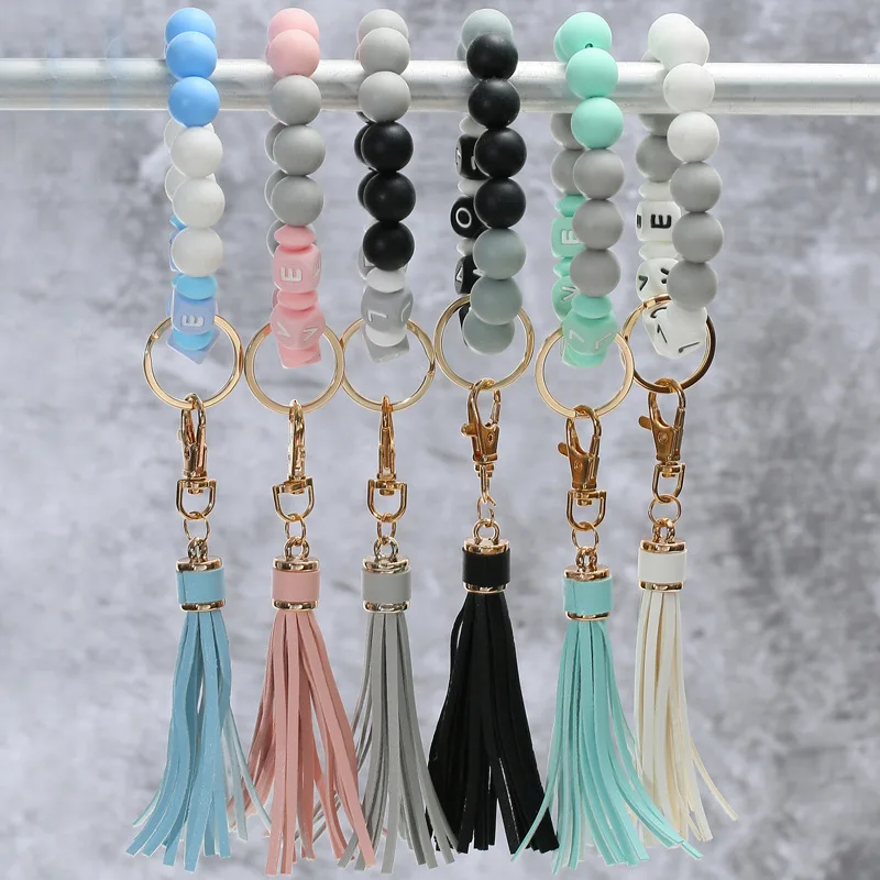 

2022 New Design Letter LOVE Silicone Bead Bracelet Wristband Keyring Leather Tassel Pendat Fashion Anti Lost Charm Keychain Gift