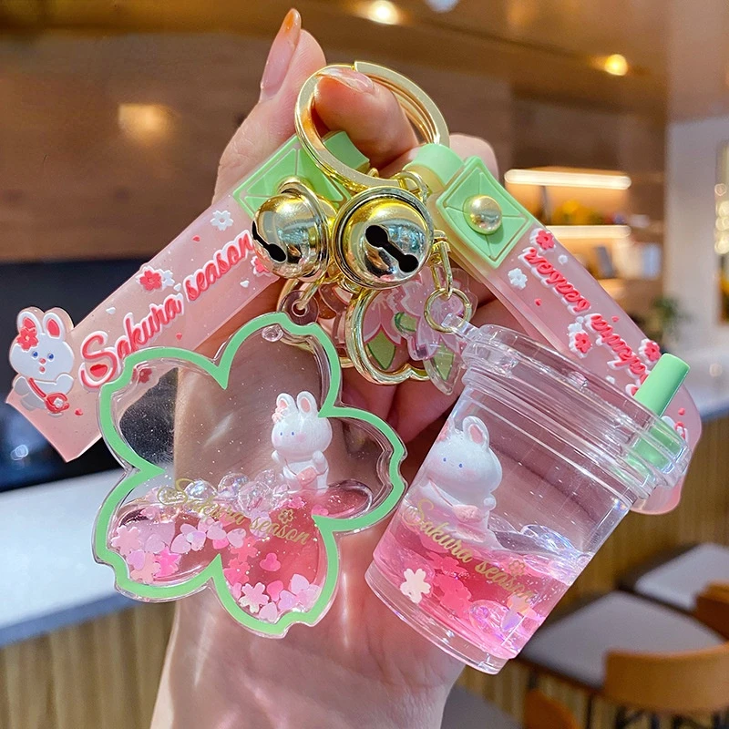 

Creative floating Cherry blossoms Rabbit Keychain Liquid Oil Rabbit Moving Milk tea cup Acrylic Keyring Quicksand Key Chain Gift