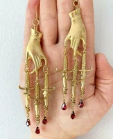 the golden hand dagger earringsgothic earringsstatement earrings witchy gothic hand and swords ruby gifts for her